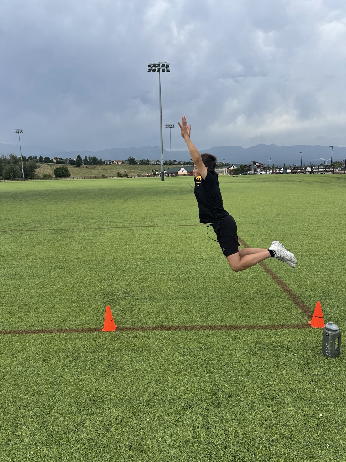 COR1 athlete developing explosive lower-body power during a field training session